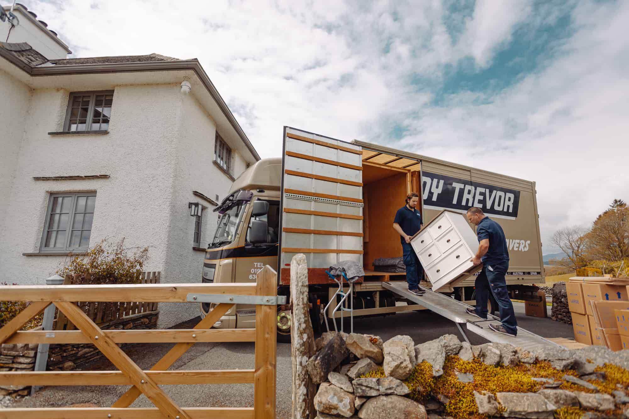 Roy Trevor team loading chest of drawers into vehicle