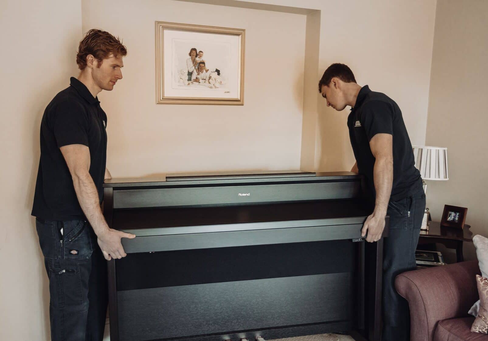 Roy Trevor team moving a piano