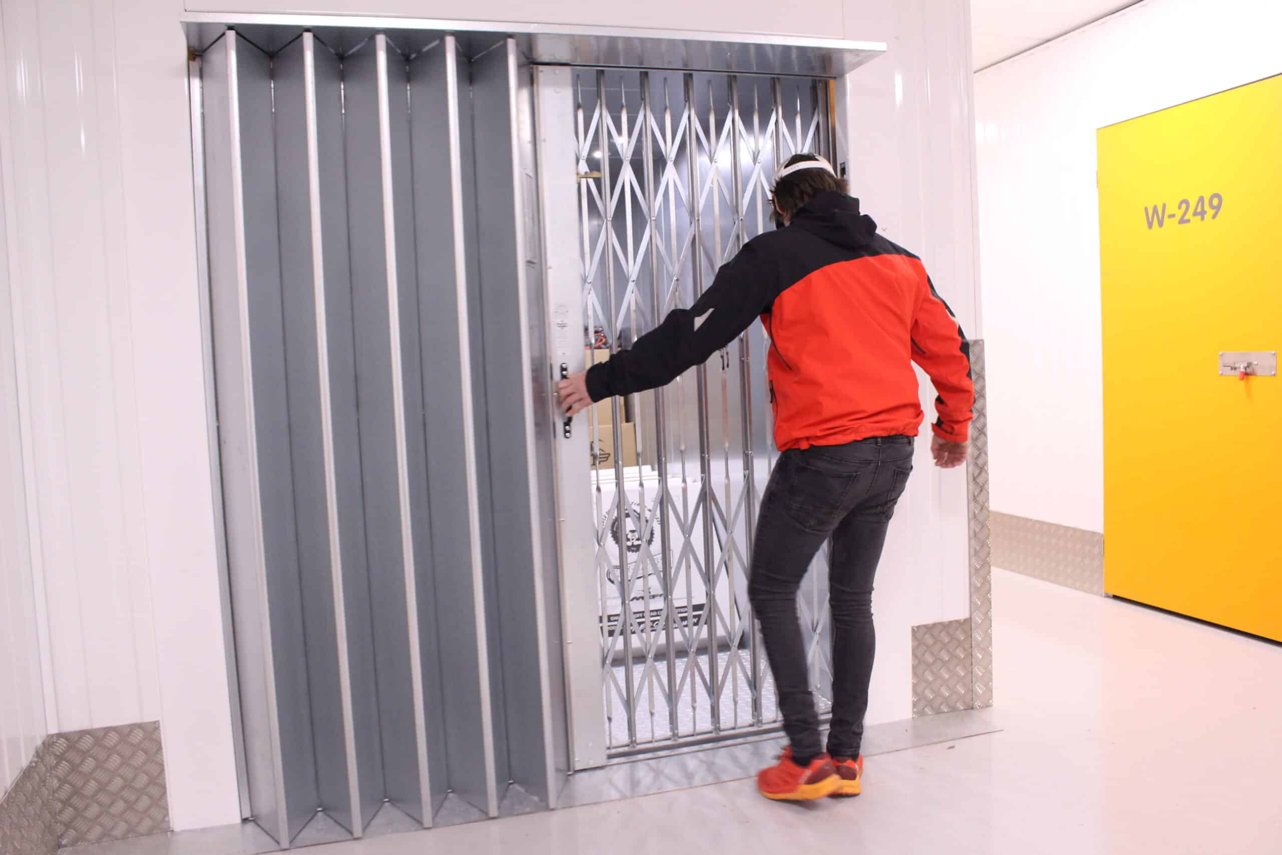 man closing lift in self storage facility