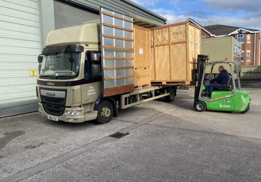 Fork lift truck unloading wooden crates