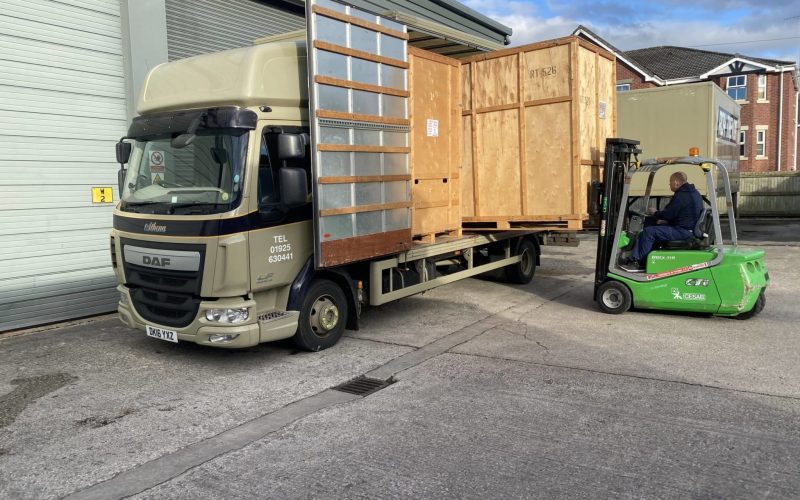 Fork lift truck unloading wooden crates