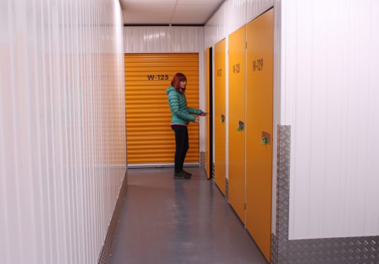 woman in checking her self storage units