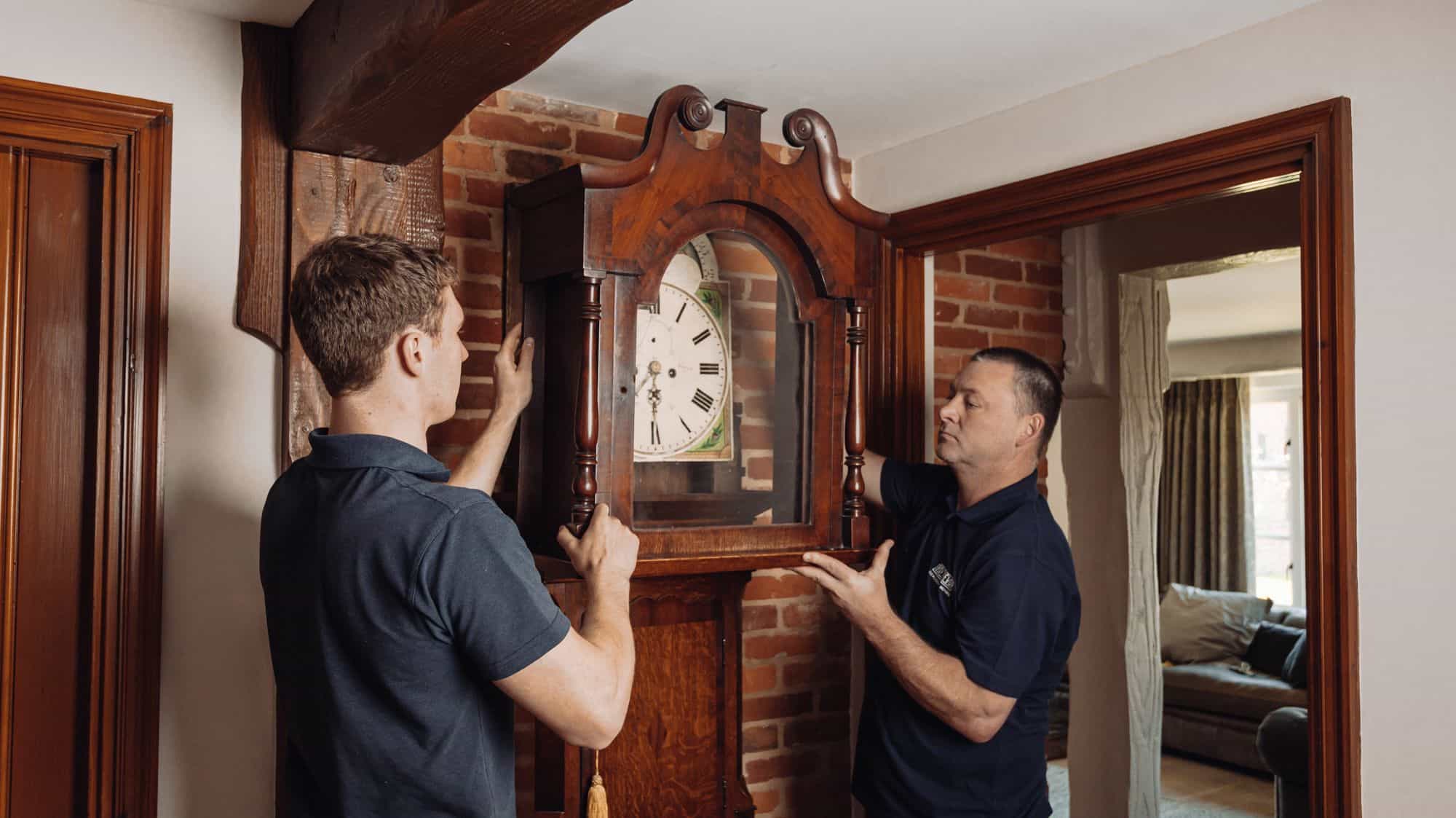 roy trevor team moving a grandfather clock